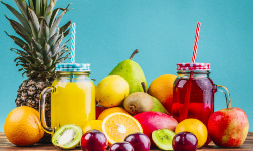 fresh-healthy-fruits-juice-mason-jars-table-against-blue-background_23-2147968645